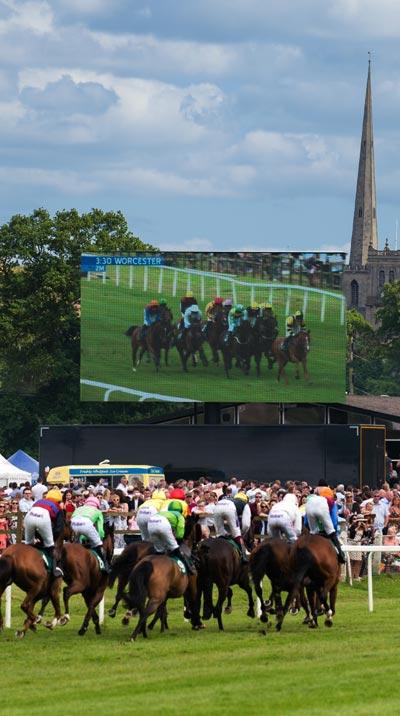 Jockeys racing with cctv in the background.