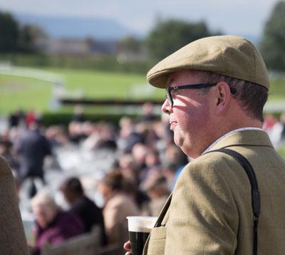 Jockeys racing past the crowds.