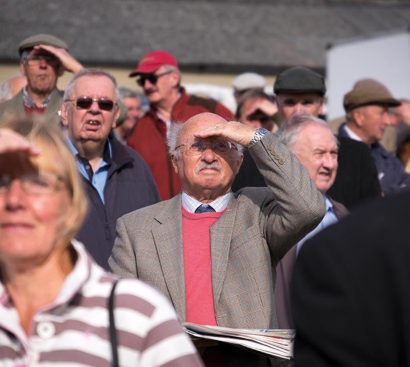 Racegoers looking towards the camera.